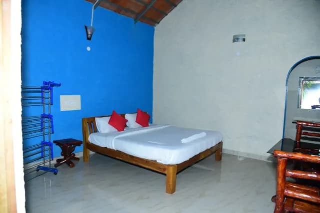 Twin beds with red cushions against a blue wall